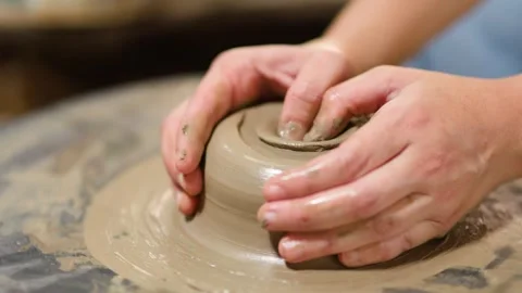 Artisan Hands Shaping Wet Clay on a Rotating Pottery Wheel Video stock 341642395
