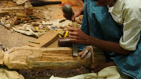 Artisan making a Buddha statue from teak wood piece - Myanmar Stock Footage 61204574