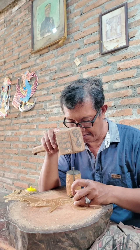 Artisan Man making Traditional Javanese wayang golek wooden puppets Stock Footage 337194165