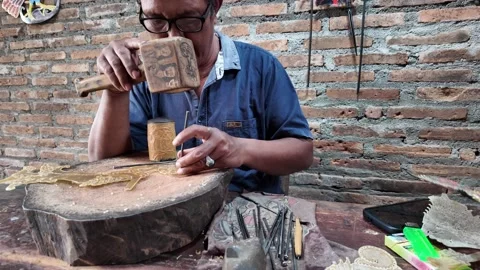 Artisan Man making Traditional Javanese wayang golek wooden puppets Stock Footage 337194167