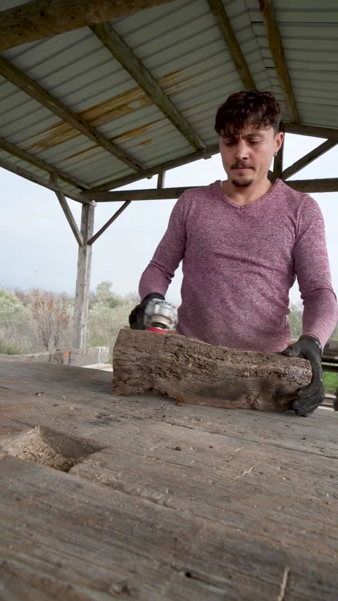 Artisan placing a heavy chestnut log on a workbench Stock Footage 325206581