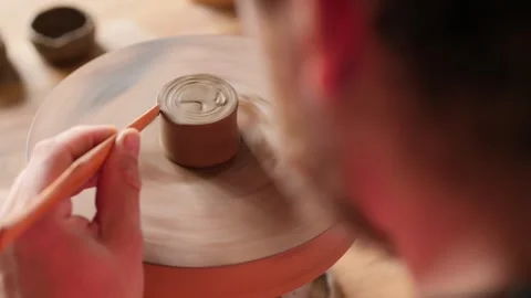 Artisan potter shaping a cone-shaped bowl on a potter's wheel. pottery concept Stock Footage 145544221