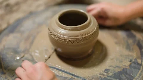 Artisan Potter Using Wire Tool to Remove Clay Pot from Wheel Stock Footage 341537834