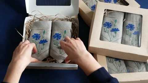 Artisan is putting goods into cardboard boxes Stock Footage