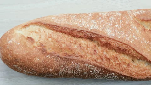 Artisan quality of a loaf of bread. Slider shot of freshly baked French Baguette Stock Footage 296564958