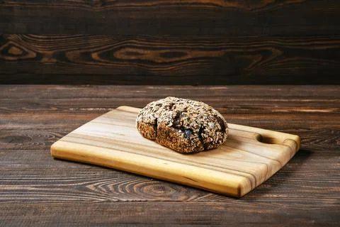 Artisan rye bread with dried apricots, prunes and sunflower seeds on cutting  Stock Photos