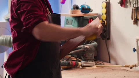 Artisan with safety glasses next to apprentice using sanding block Video stock 271097560