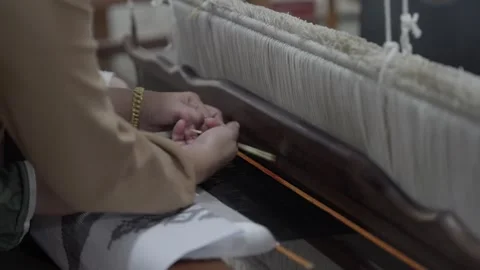 Artisan setting pattern sticks on songket warp Stock Footage 309290733