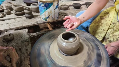 Artisan Shaping Clay Pottery on Spinning Wheel in Koh Kret Workshop Stock Footage 341536612