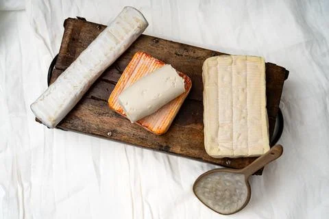 Artisan Soft Cheese Selection on Rustic Wooden Board 写真素材