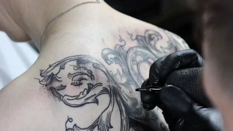 Artisan tattooist working on shoulder design. Close-up, slow-motion Stock Footage 306848371