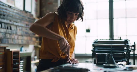 Artisan typesetter mixing inks for printmaking in letterpress studio with bright Stock-Footage 199459577