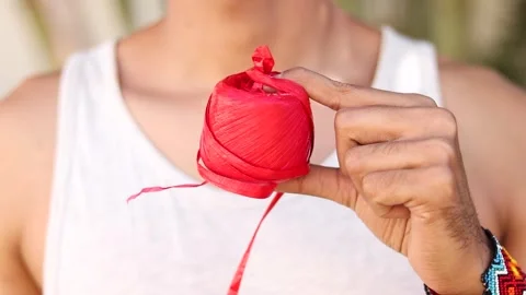 Artisan Unwinding Red Raffia for Craft. Close-Up Unrecognisable Man Video stock 264900876