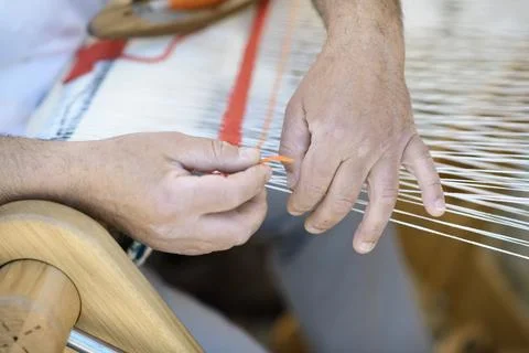 Artisan Weaves Wool Thread on Loom Stock Photos