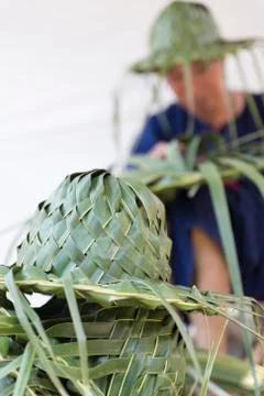 Artisan weaving palm leaf for making hat Stock Photos