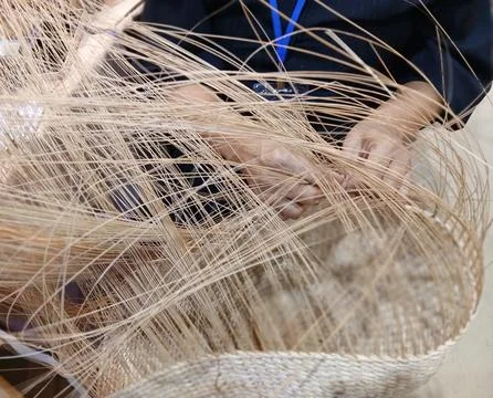 Artisan weaving traditional basket using nypa palm fronds as a creative craft Stock Photos