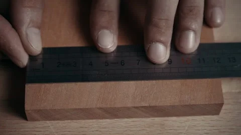 Artisan Woodworker Marking the Width of Mahogany Dowel Joints with Precision Stock Footage 252148158