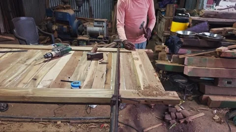 Artisan woodworking in a rustic workshop with tools and wood planks on a wo.. Stock Footage 266864186