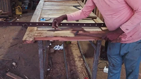 Artisan woodworking in a rustic workshop with tools and wood planks on a wo.. Stock Footage 266864198