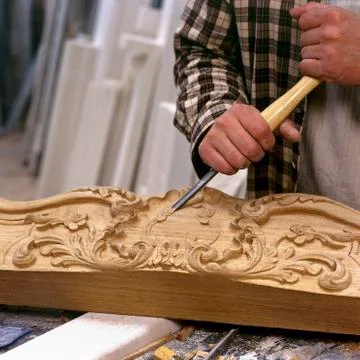 Artisan working with chisel Stock Photos