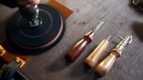 Artisan working with leather. Stock Photos