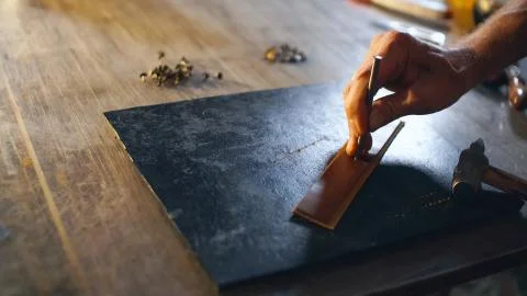Artisan working with leather. Stock Photos