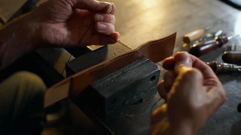 Artisan working with leather. Stock Photos