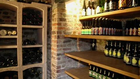 Artisanal Beer Cellar Bottles and Brick Shelves Interior Panning Shot 스톡 동영상 346883663