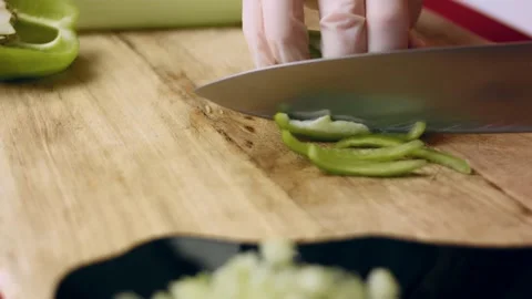 Artisanal chef knife slicing white onion on a wooden board in macro, 4K Stock Footage 341107272
