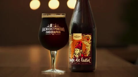 Artisanal Craft Beer Elegance, Craft dark beer in bottle and filled glass on Stock Footage 257768182