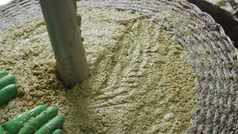 Artisanal Olive Oil Extraction Process. Filling Baskets for pressing 06 Stock Footage 299673864
