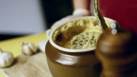 Artisanal roasted potato pieces presented beside garlic and herbs in macro, 4K Stock Footage 341103717