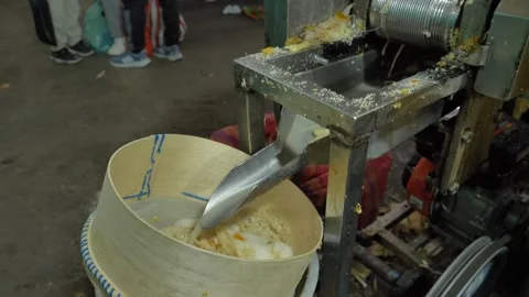 An artisanal sugarcane juice extraction machine on a table Stock Footage 328972676