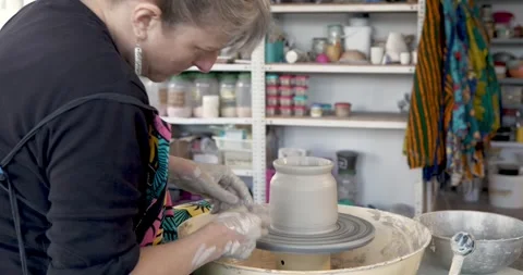 Artisan's Craft: A skilled artisan meticulously molds wet clay Stock Footage 329306841
