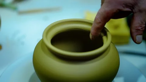 Artisan's hand gently checking the rim of a freshly molded clay pot. Stock Footage 328925271