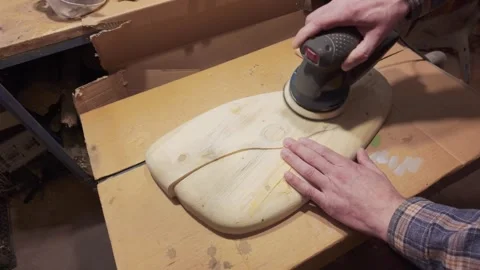 A artisans hand guides an orbital sander over the surface of a handcrafted .. Vídeo Stock 333149278
