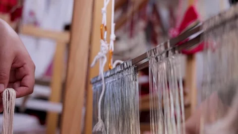 Artisans Preparing Warp Threads on a Traditional Loom Stock Footage 339375585