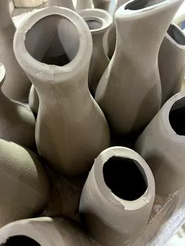 Artisans shape clay into elegant vases, showcasing their skills in a pottery  Stock Photos