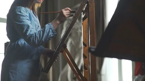 Artist in atmospheric workshop with panoramic windows, antique statue Stock Footage 74995564
