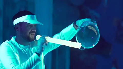 The artist blows big soap bubbles. corporate party of children Video stock 131608253