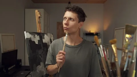 Artist comes up with creative idea while thinking in calm home studio Stock Footage 312636405