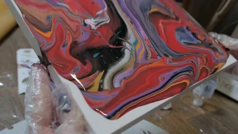 The artist creates a picture using liquid ink. Create an abstract painting Stock Footage 195358543