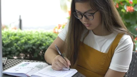 Artist Drawing and Taking Notes Outside at Cafe Stock Footage 114708992