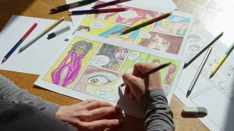 An artist draws comic book characters on paper with a pencil.  Stock Footage 172497773