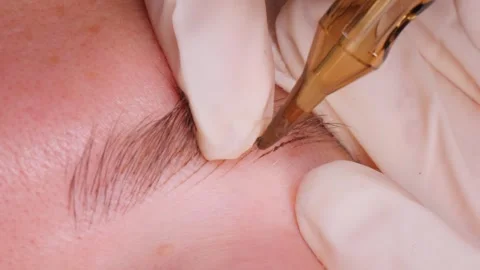 Artist draws delicate lines to simulate natural eyebrow hair Stock Footage 277441462