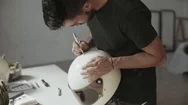 Artist Draws Hand Lettering On Vintage Helmet Stock Footage