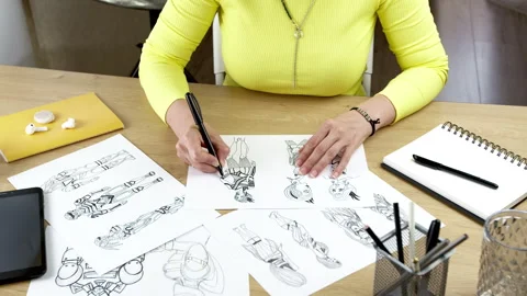 The artist draws on paper characters for computer games or comics. Stock Footage 245747629