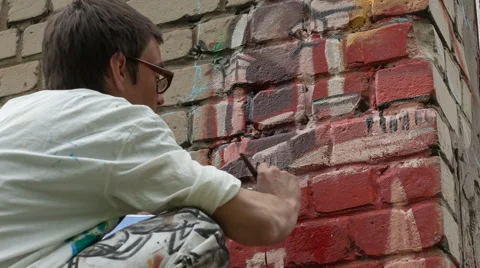 Artist draws on the wall Stock Footage 63030935