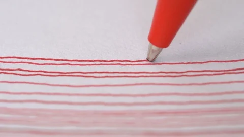 Artist hand drawing red line with ball pen on white paper, macro Stock Footage