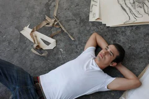 Artist lying on studio floor Stock Photos